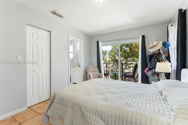 a bedroom with a large bed and a window