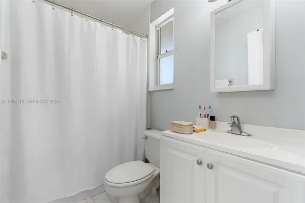 a bathroom with a sink toilet and vanity