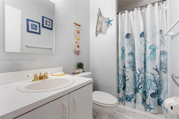 a bathroom with a sink toilet and a shower