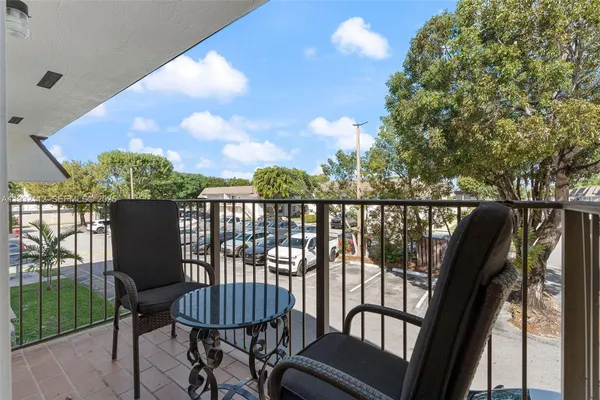 a view of a balcony with chair and table