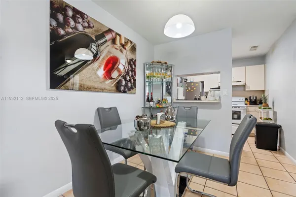 a dining room with furniture and painting on the wall