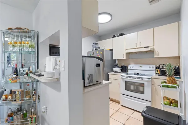 a kitchen with stainless steel appliances white cabinets and a refrigerator