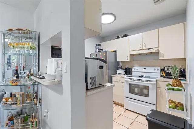 a kitchen with stainless steel appliances white cabinets and a refrigerator
