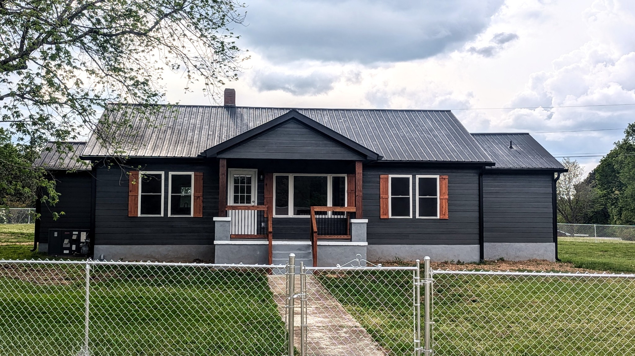 a front view of a house with a garden