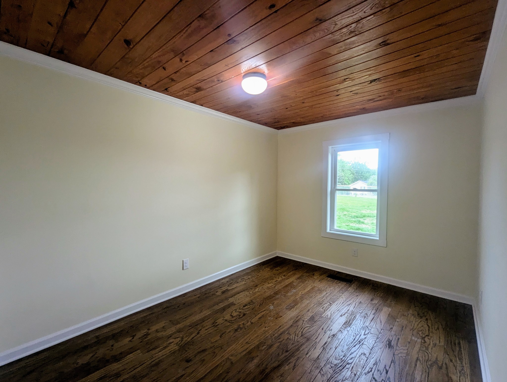 1263 Highway 100 Centerville, TN 37033 - Photo 8 of 17 a view of an empty room with wooden floor and a window