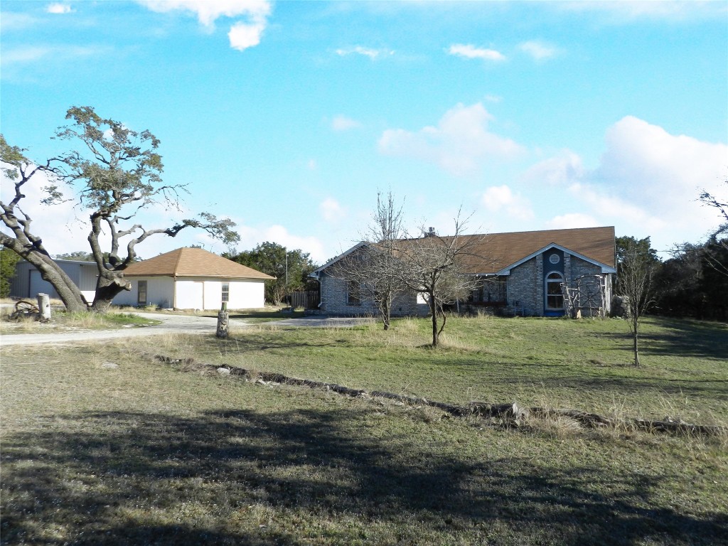a view of a big yard with large trees