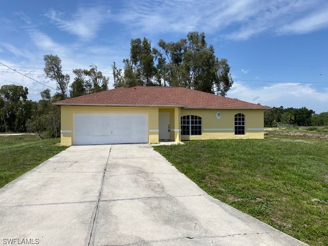 247 Rue Labonne Road Fort Myers, FL 33913 - Photo 1 of 14 a front view of a house with a yard