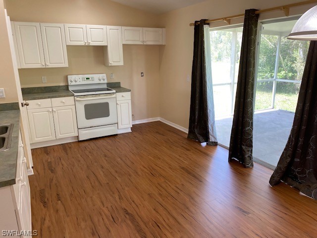 247 Rue Labonne Road Fort Myers, FL 33913 - Photo 8 of 14 a kitchen with a hard wood floor and a stove