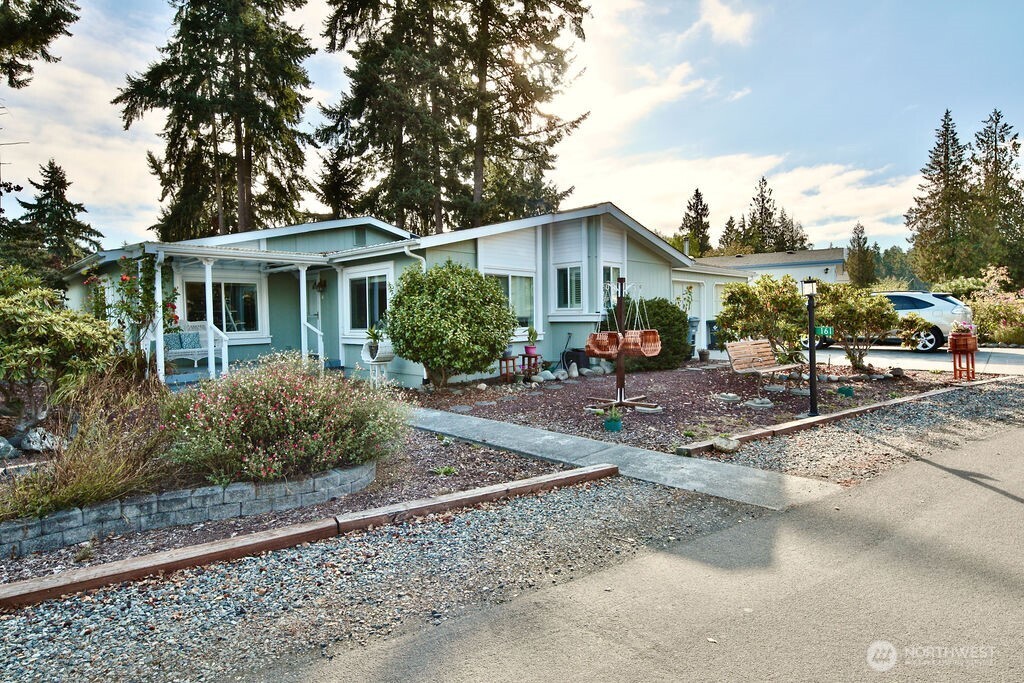 a view of a house with backyard porch and sitting area