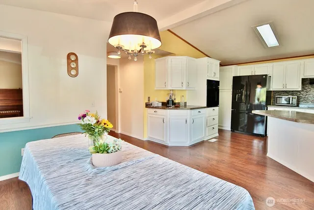 a view of kitchen with sink and refrigerator