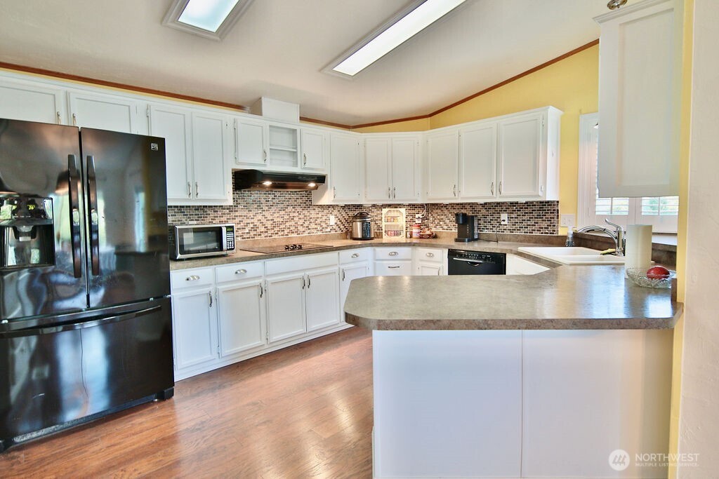 161 Fircrest Drive Sequim, WA 98382 - Photo 13 of 33 a kitchen with stainless steel appliances granite countertop a sink a stove a refrigerator and a granite counter tops