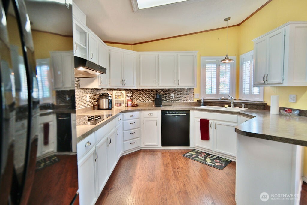 161 Fircrest Drive Sequim, WA 98382 - Photo 15 of 33 a kitchen with stainless steel appliances granite countertop a stove a sink and a refrigerator