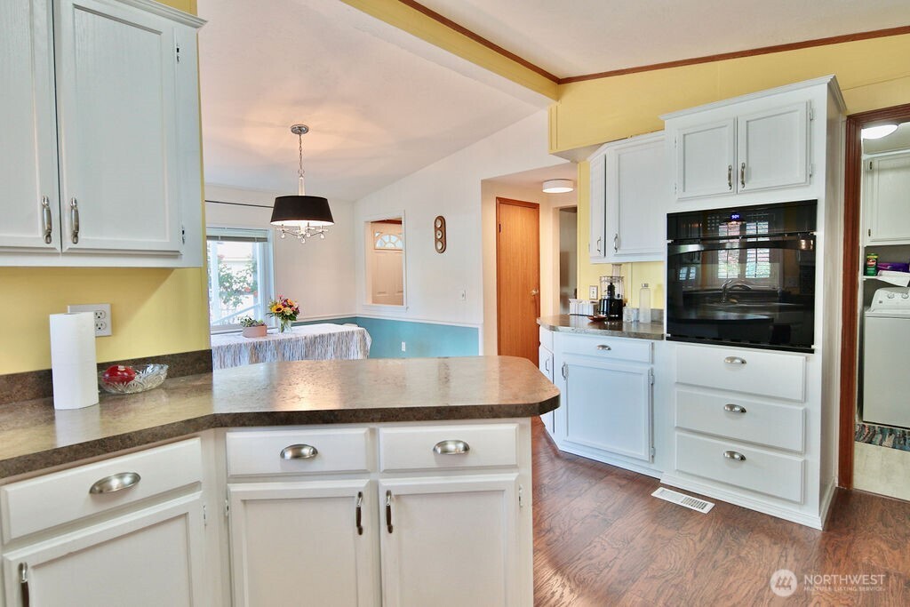 161 Fircrest Drive Sequim, WA 98382 - Photo 16 of 33 a kitchen with stainless steel appliances white cabinets a sink and a stove