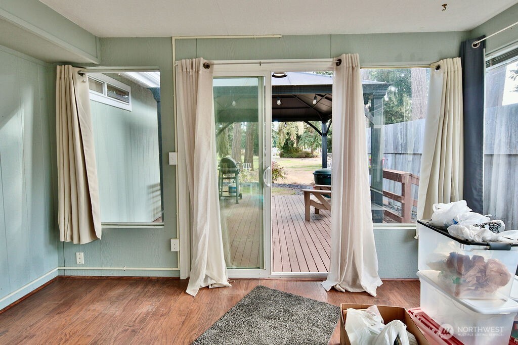 161 Fircrest Drive Sequim, WA 98382 - Photo 19 of 33 a view of a hallway with wooden floor and windows