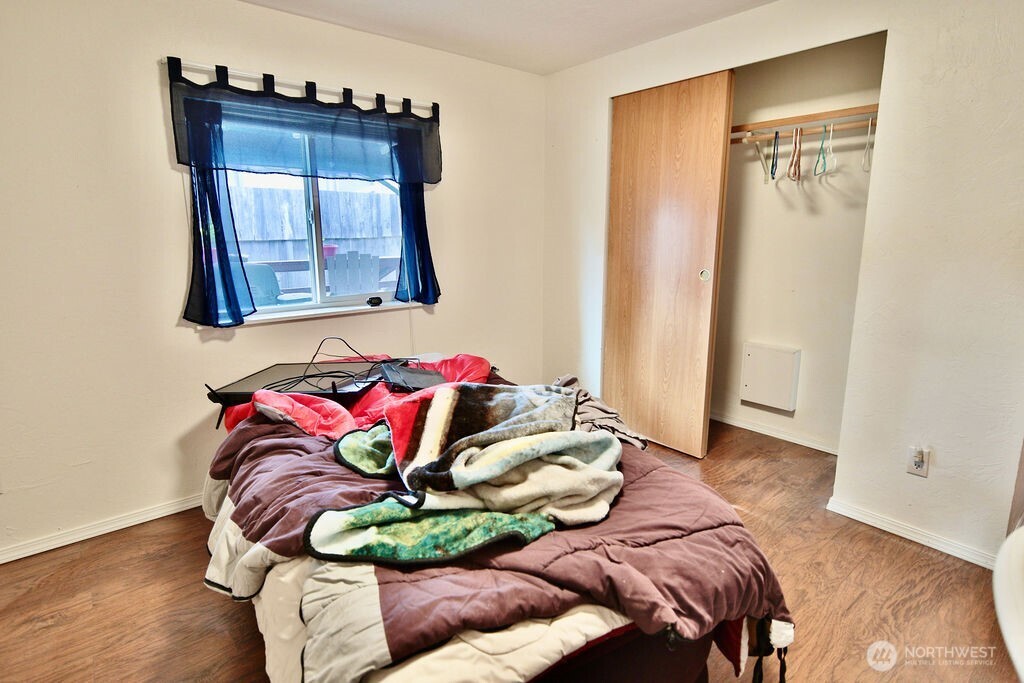 161 Fircrest Drive Sequim, WA 98382 - Photo 23 of 33 a bedroom with a bed and a painting on the wall