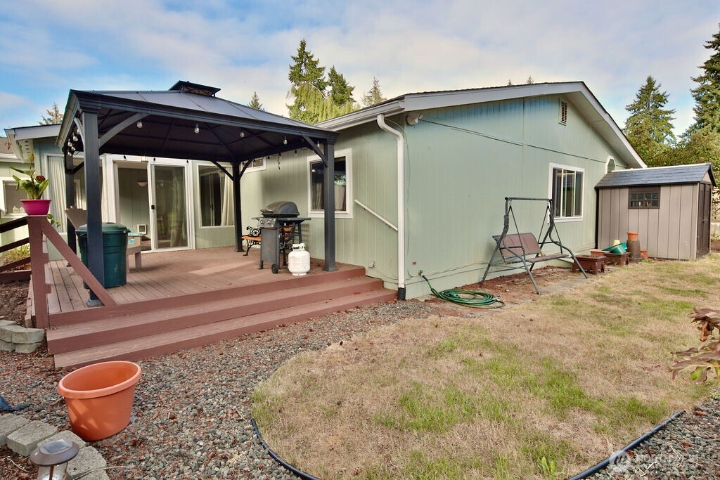 161 Fircrest Drive Sequim, WA 98382 - Photo 30 of 33 a view of a porch with a table and chairs