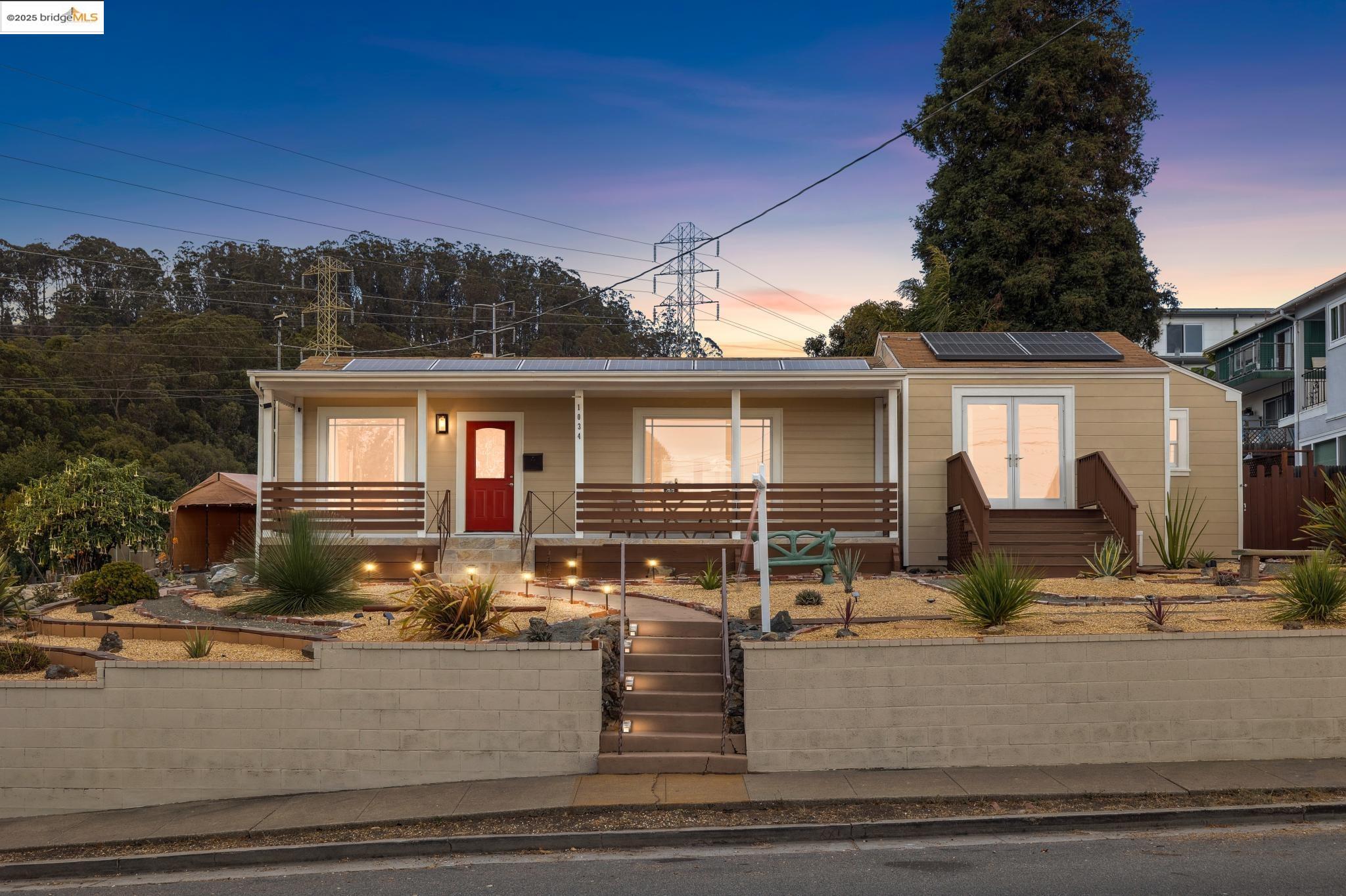 1034 Navellier Street El Cerrito, CA 94530 - Photo 1 of 57 View of front of house featuring a porch, solar panels, a gate, and a fenced front yard