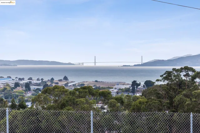 a kitchen with stainless steel appliances kitchen island granite countertop a stove a sink a dining table and chairs