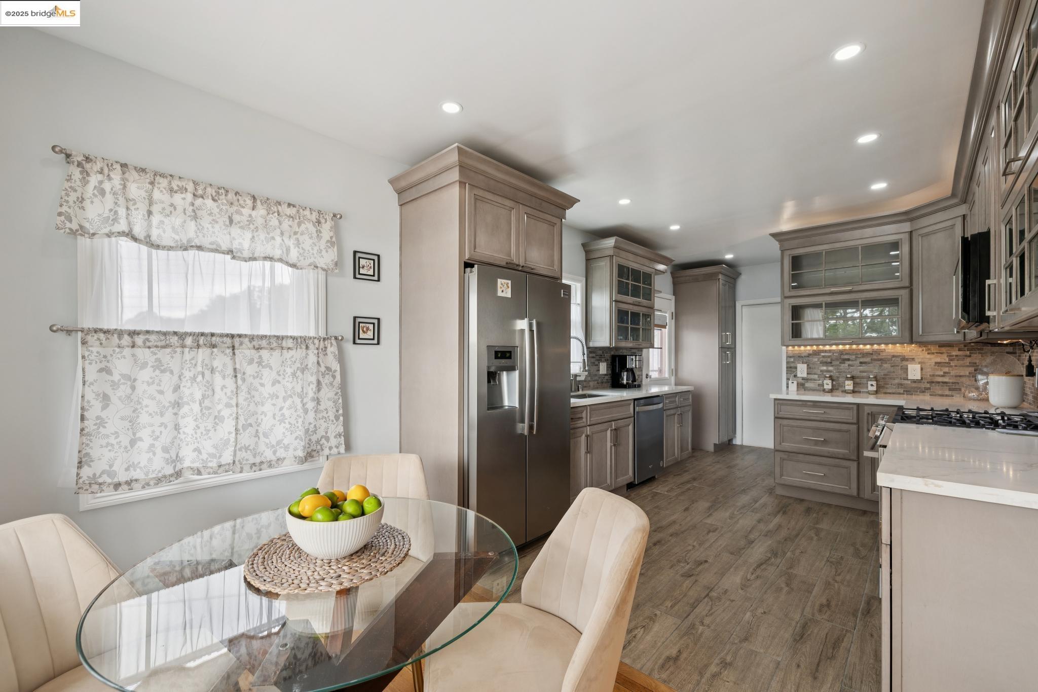 1034 Navellier Street El Cerrito, CA 94530 - Photo 16 of 57 a kitchen with stainless steel appliances a refrigerator a sink a stove a dining table and chairs