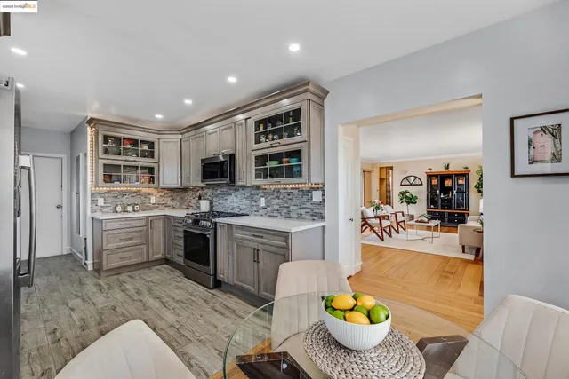 a kitchen with stainless steel appliances a stove a sink and a microwave