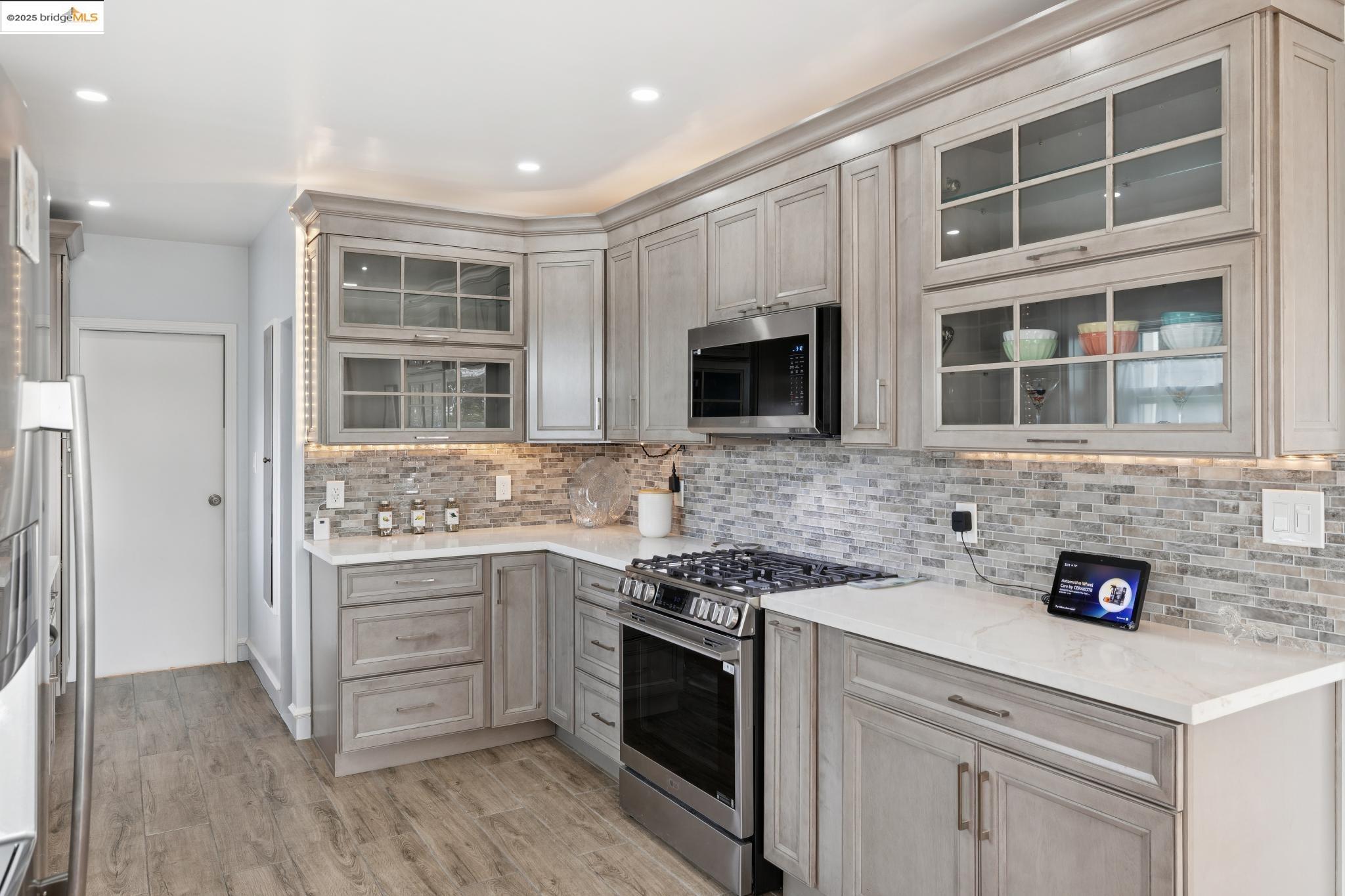 1034 Navellier Street El Cerrito, CA 94530 - Photo 19 of 57 a kitchen with stainless steel appliances granite countertop a stove and a sink