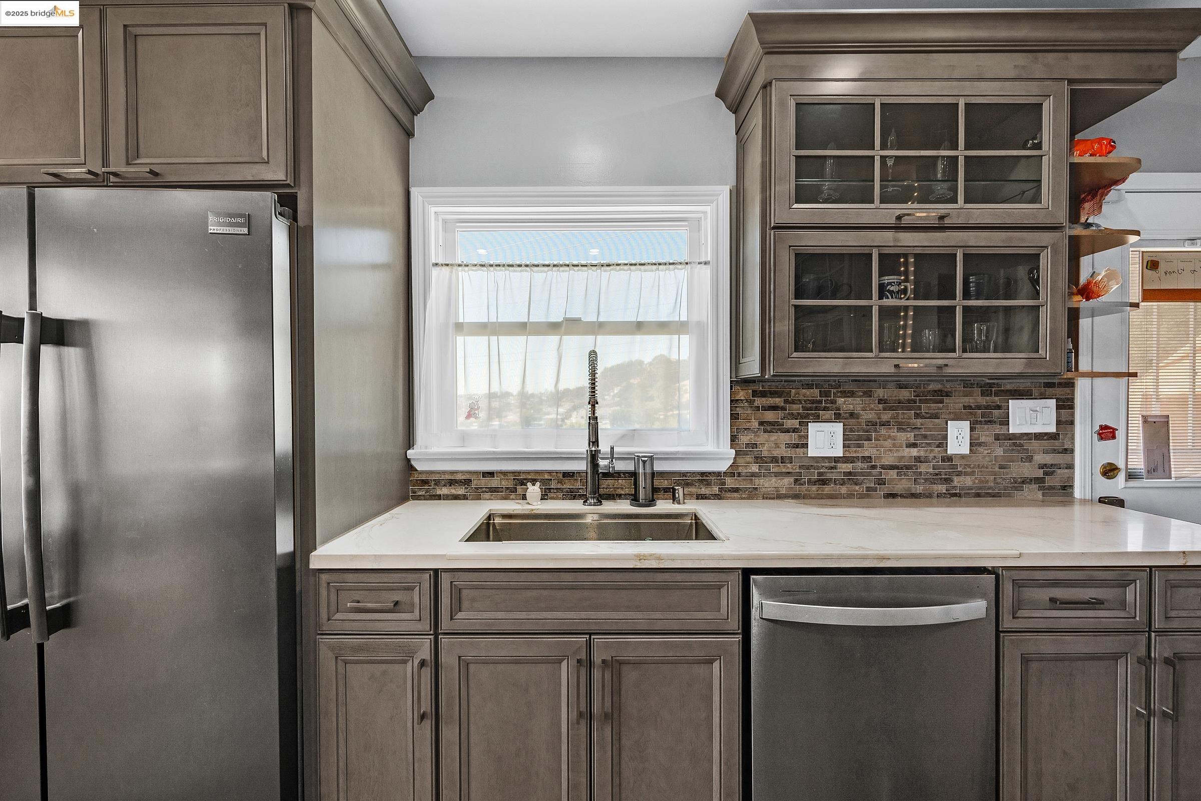 1034 Navellier Street El Cerrito, CA 94530 - Photo 21 of 57 a kitchen with a sink and a refrigerator