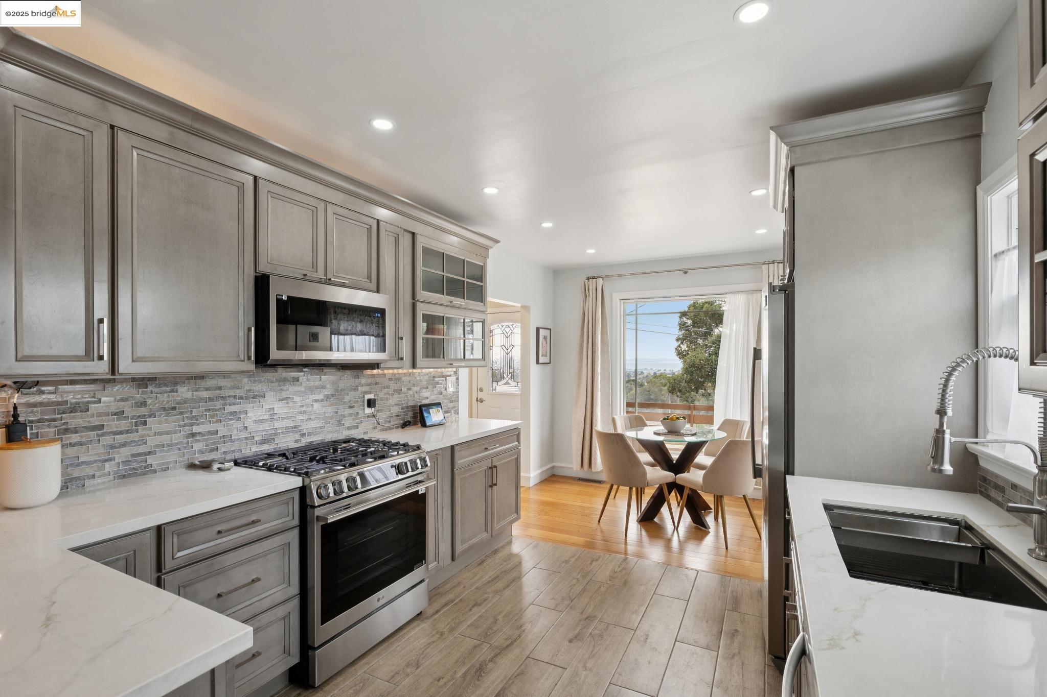 1034 Navellier Street El Cerrito, CA 94530 - Photo 22 of 57 a kitchen with stainless steel appliances a stove a sink and a microwave