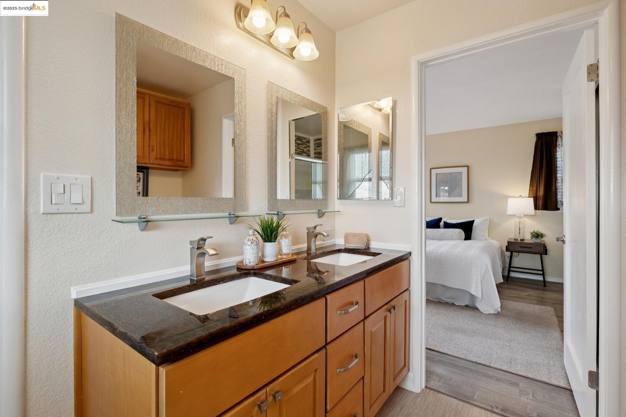 1034 Navellier Street El Cerrito, CA 94530 - Photo 37 of 57 a bathroom with a granite countertop sink and a mirror