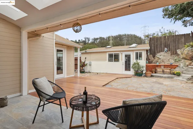 a living room with stainless steel appliances kitchen island granite countertop furniture and a dining table