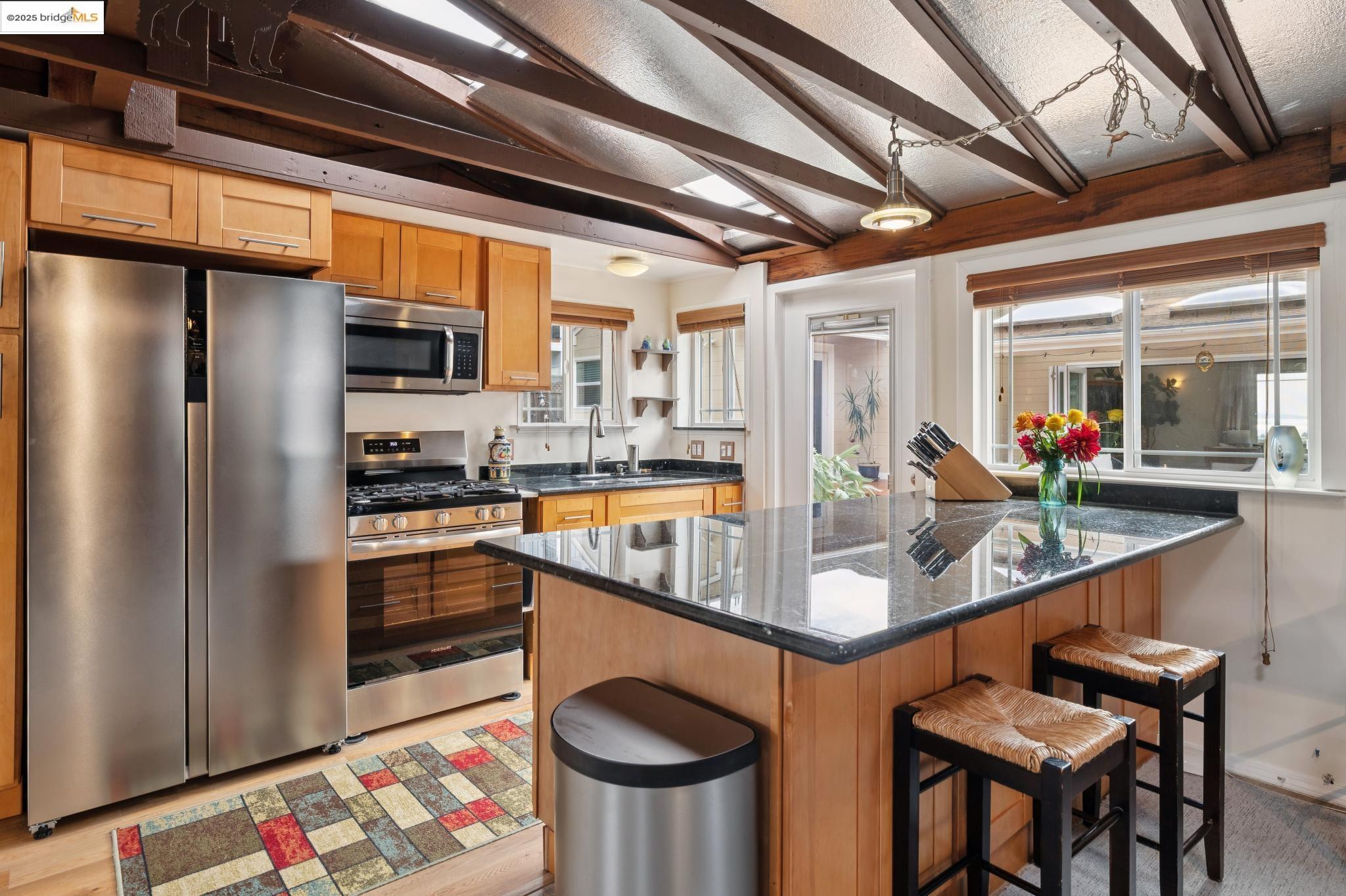 1034 Navellier Street El Cerrito, CA 94530 - Photo 52 of 57 a kitchen with stainless steel appliances granite countertop a sink and a refrigerator