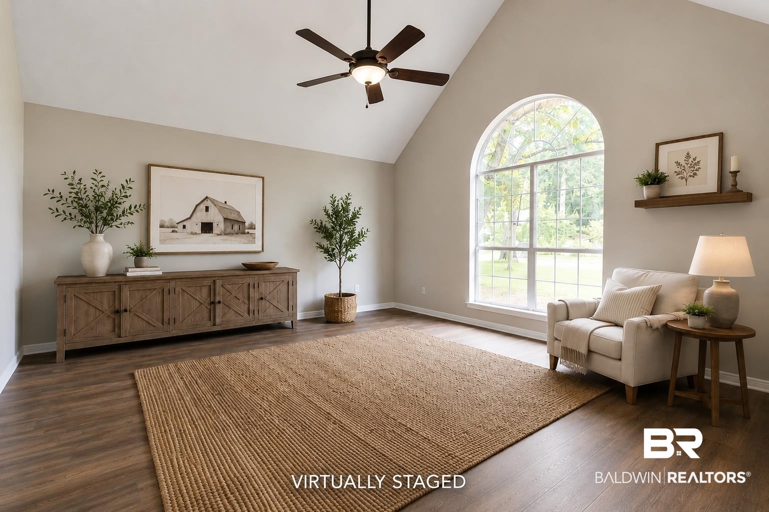 101 Lawson Road Daphne, AL 36526 - Photo 5 of 20 Virtually Staged. Spacious living area featuring vaulted ceilings, a ceiling fan with integrated lighting, wood-finish flooring, and a large arched window with grid detailing