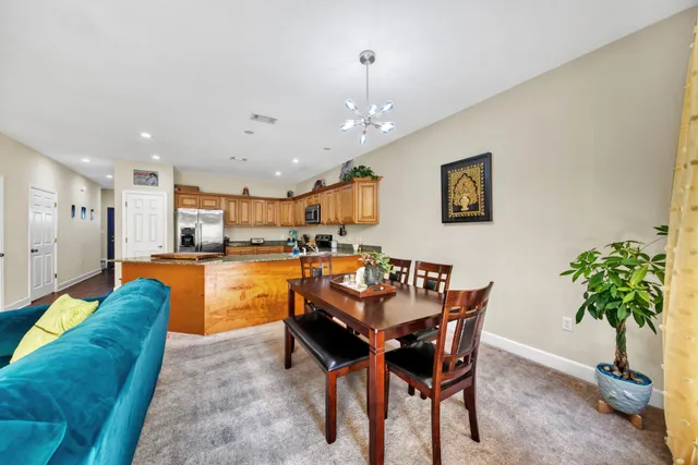 a living room with dining room and kitchen view