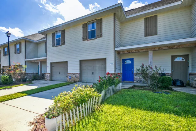 a front view of a house with a yard and porch
