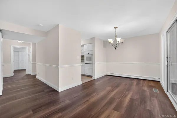 a view of a kitchen with wooden floor and a kitchen