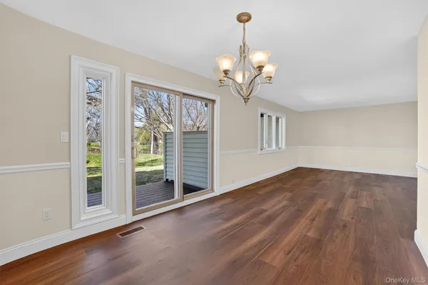 a view of a livingroom with wooden floor and a ceiling fan