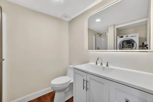 a white toilet sitting next to a bathroom sink