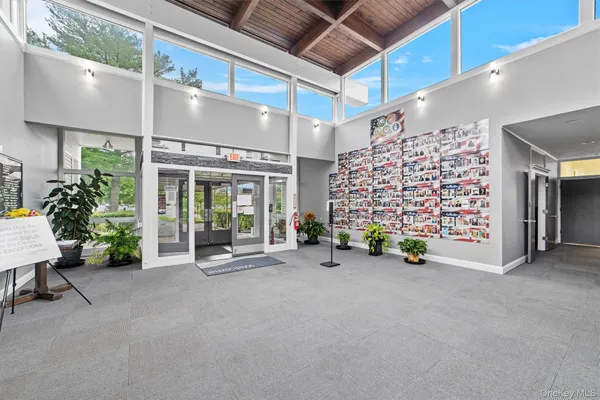 a lobby with furniture and a flat screen tv
