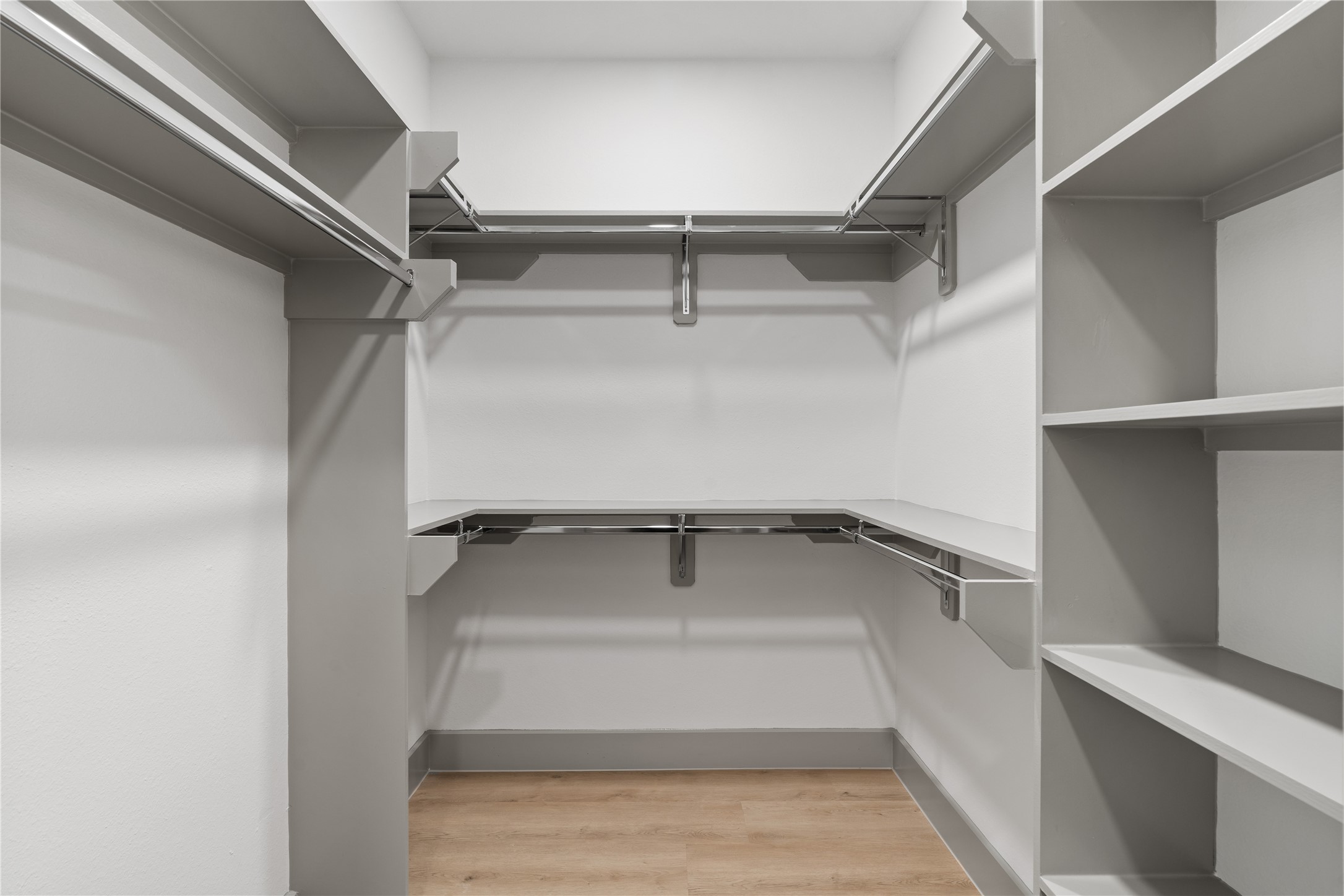 2950 Pitzlin Street Houston, TX 77023 - Photo 27 of 37 Maximize your mornings with this thoughtfully designed walk-in closet—featuring double hanging rods, built-in shelving, and ample space for everything from everyday essentials to seasonal favorites. Clean, organized, and ready for your routine.