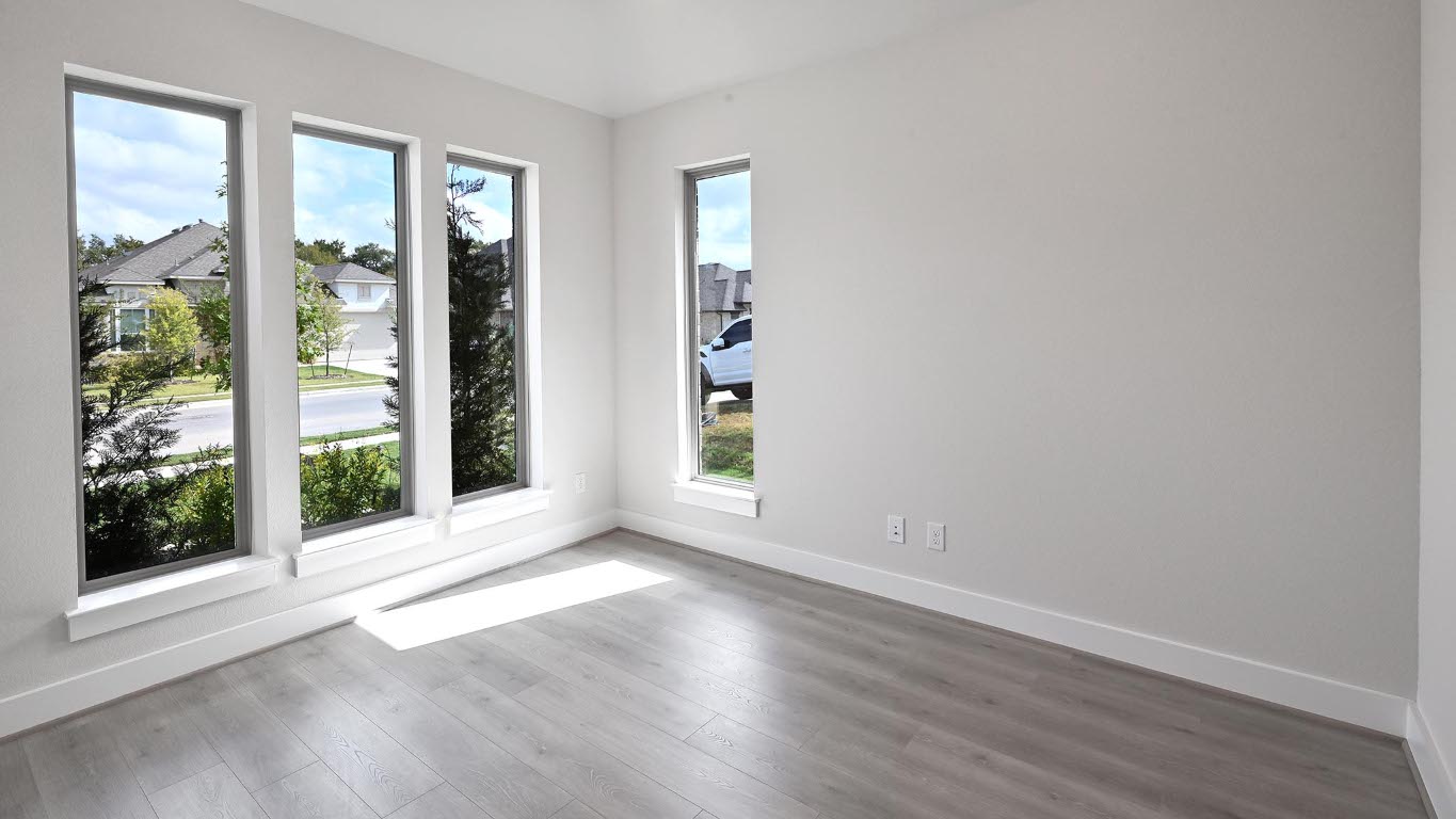 136 Brewer Street Kyle, TX 78640 - Photo 12 of 40 Spare room featuring baseboards and wood finished floors