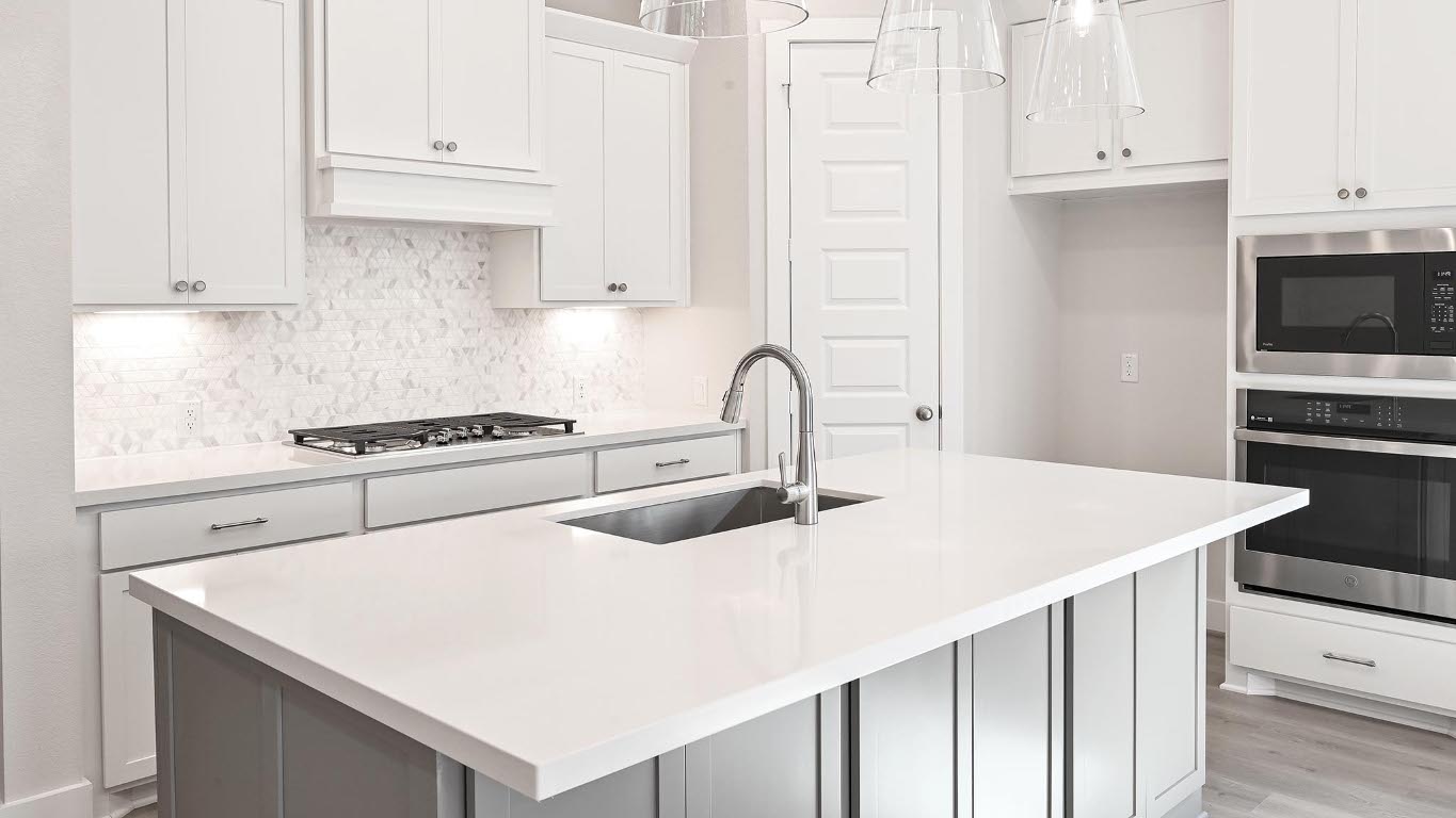 136 Brewer Street Kyle, TX 78640 - Photo 8 of 40 Kitchen with stainless steel appliances, tasteful backsplash, a kitchen island with sink, hanging light fixtures, and white cabinetry