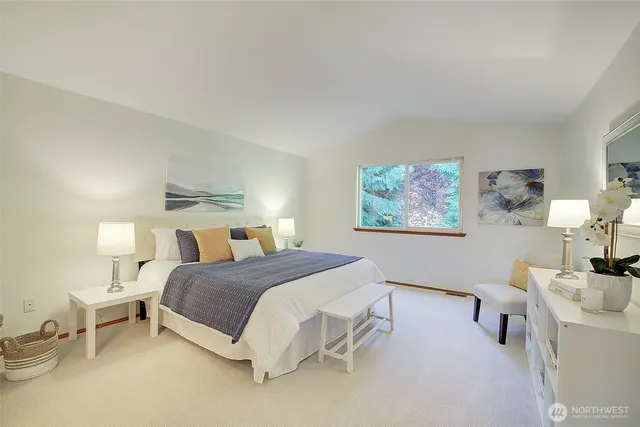 a bedroom with a bed and a lamp