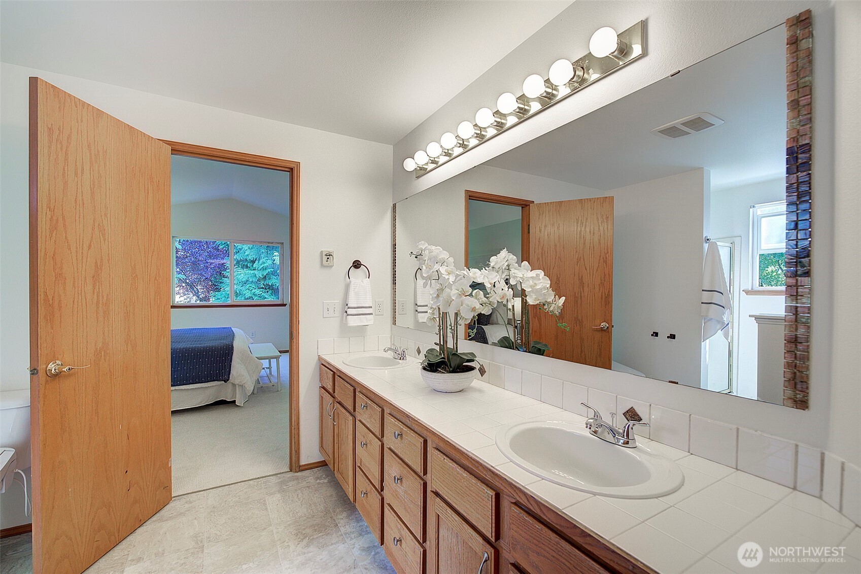 3002 200th Street Southeast Bothell, WA 98012 - Photo 19 of 34 a spacious en suite bathroom with a double vanity sink and a mirror