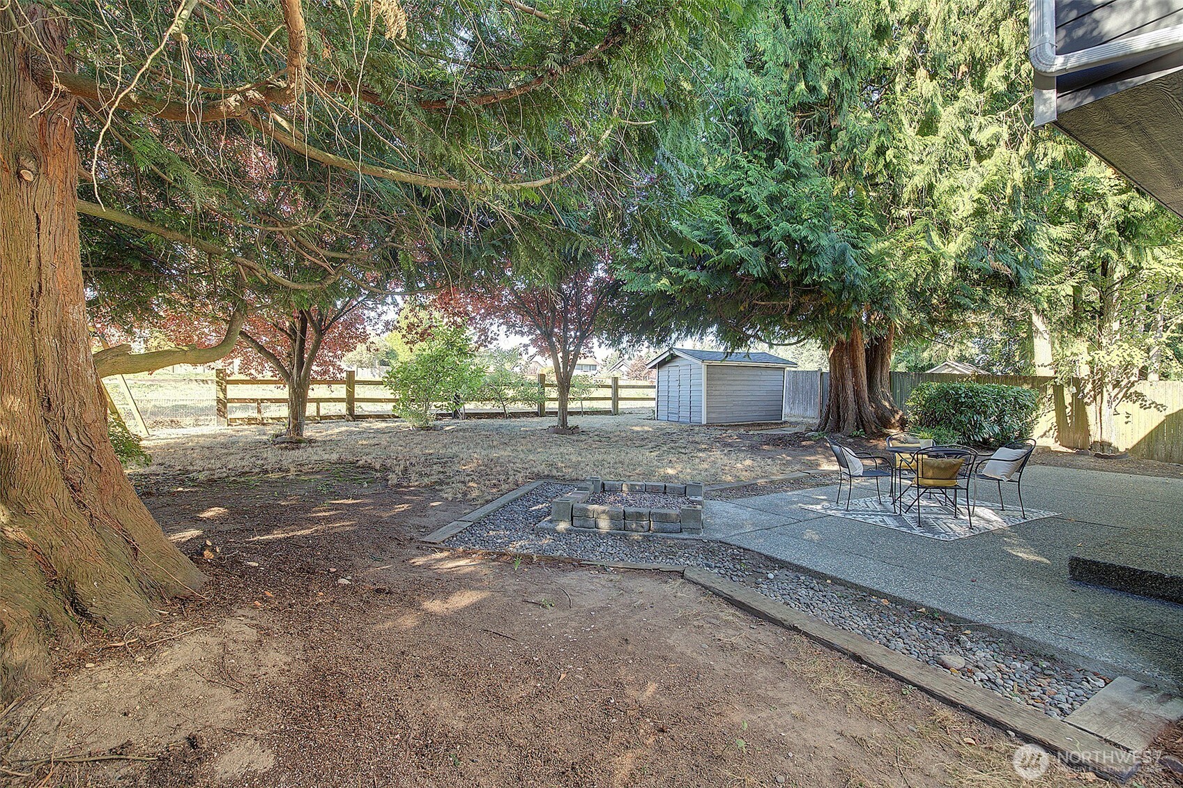 3002 200th Street Southeast Bothell, WA 98012 - Photo 31 of 34 a view of a yard with table and chairs and a large tree