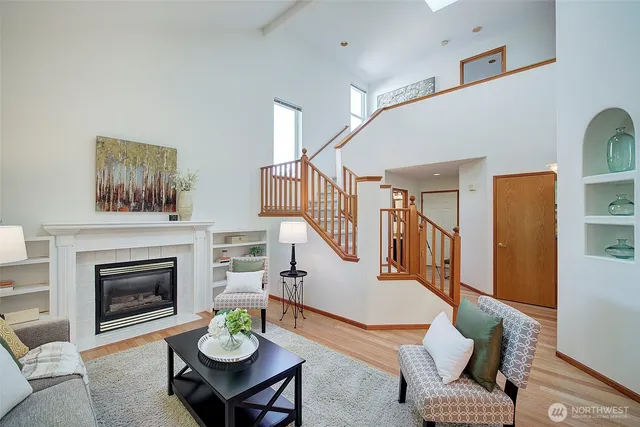a living room with furniture a fireplace and a table