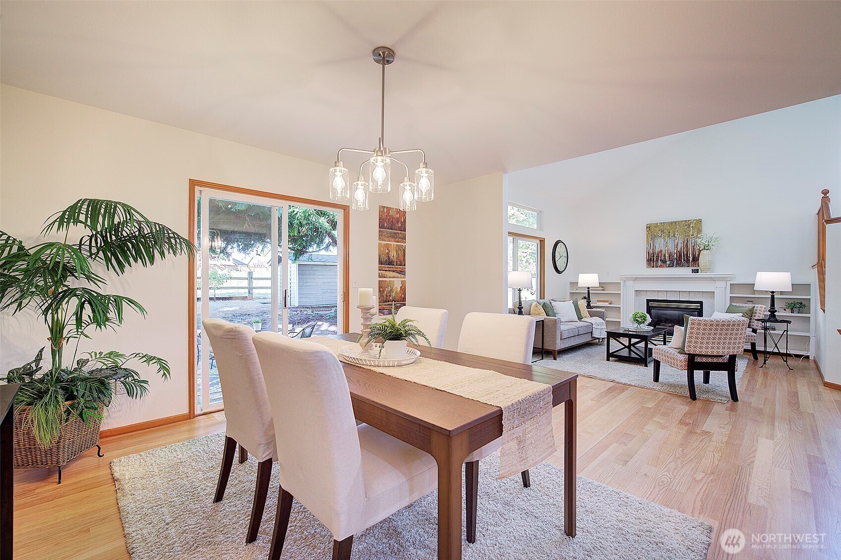 3002 200th Street Southeast Bothell, WA 98012 - Photo 7 of 34 a view of a dining room and livingroom with furniture wooden floor a chandelier