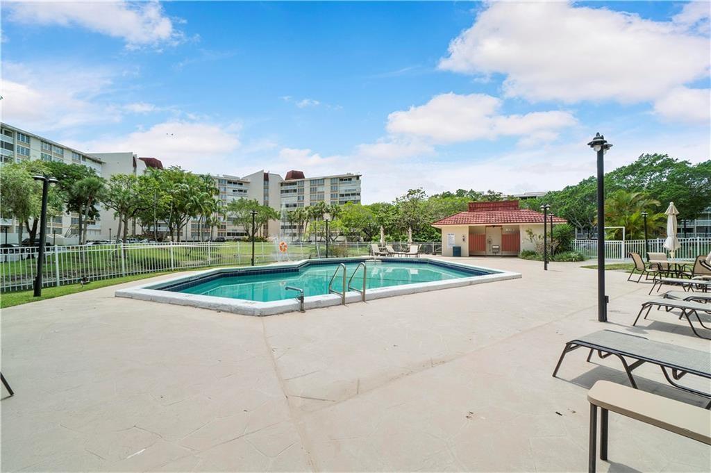 7081 Environ Boulevard, Unit 242 Lauderhill, FL 33319 - Photo 4 of 4 a view of a swimming pool and a yard
