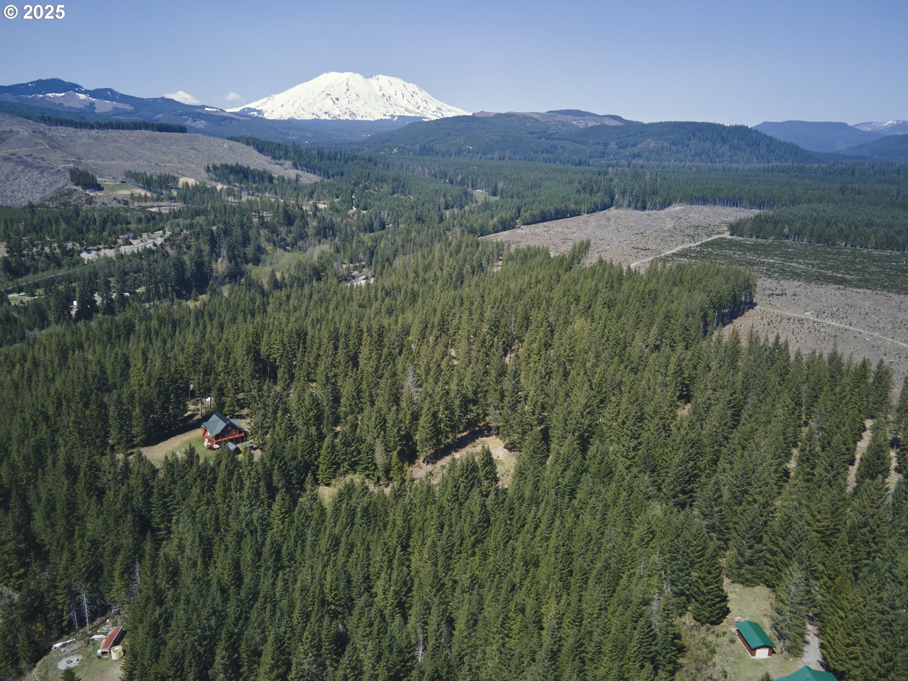 a view of a lush green hillside and a building