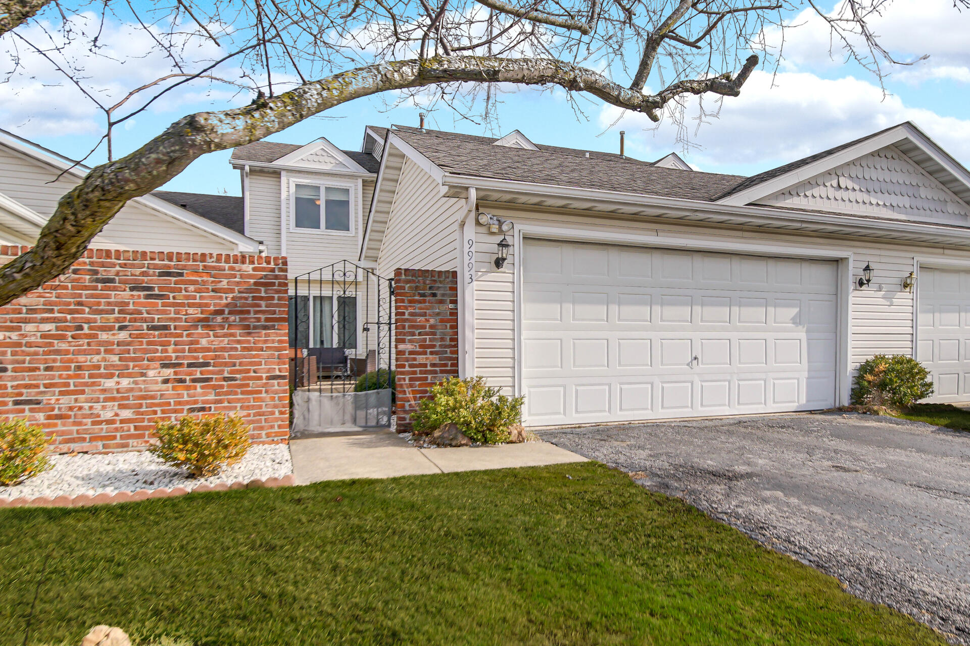 9993 Hunters Run St. John, IN 46373 - Photo 1 of 28 a front view of a house with a garden