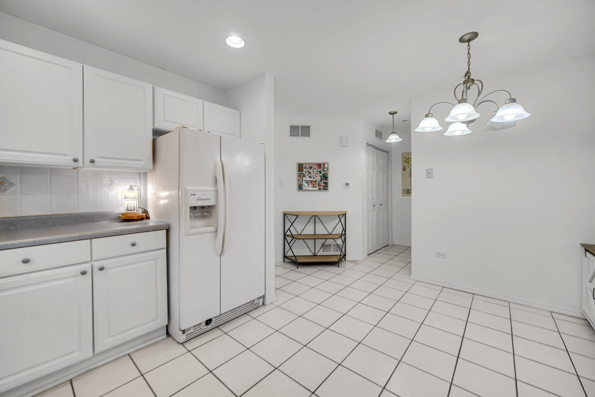 9993 Hunters Run St. John, IN 46373 - Photo 17 of 28 a view of a kitchen with cabinet and refrigerator