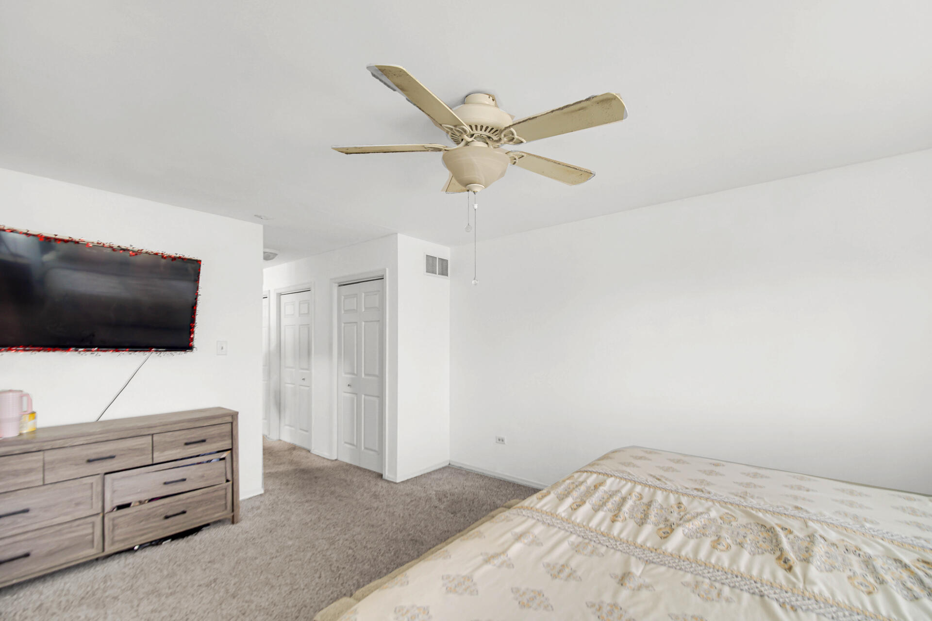 9993 Hunters Run St. John, IN 46373 - Photo 21 of 28 a bedroom with a bed and a flat screen tv